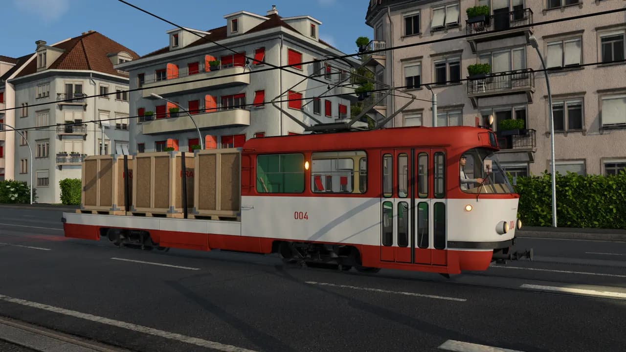 Elétrico de carga vermelho e branco com caixotes de madeira numa rua